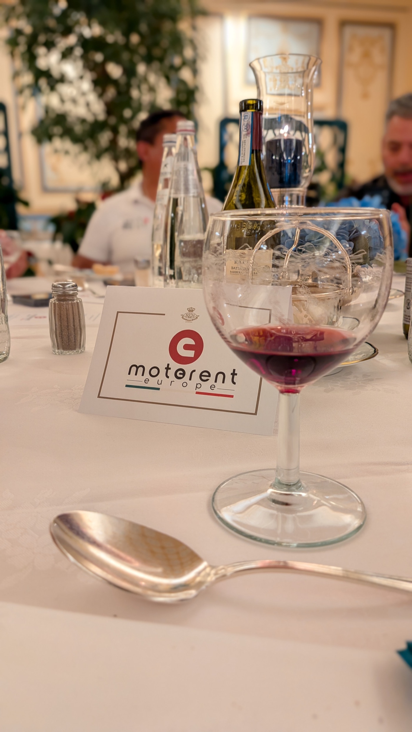 Mesa compartida con vino, comida y MotoRent Europe